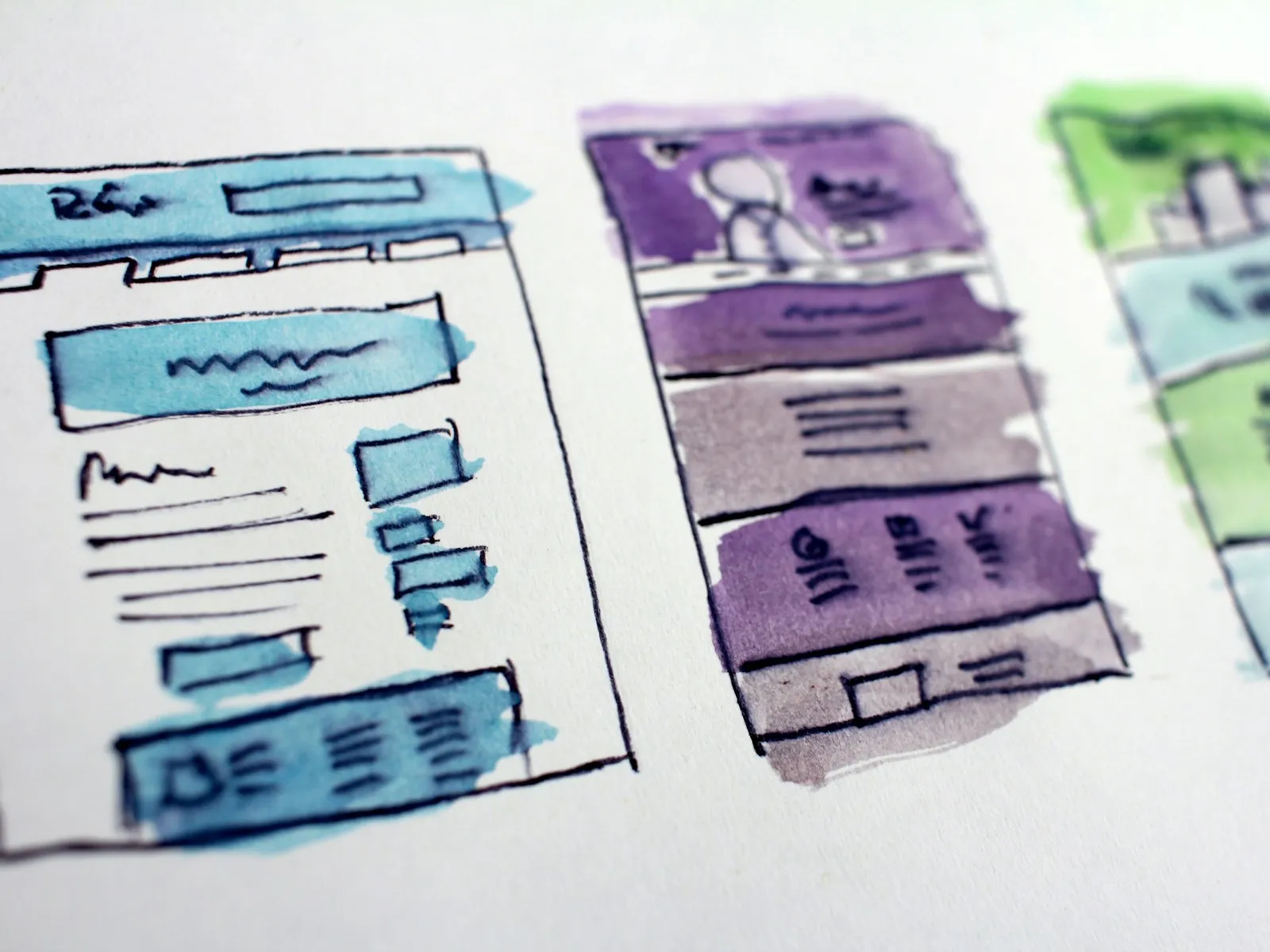 Watercolour wireframe sketches of website layouts