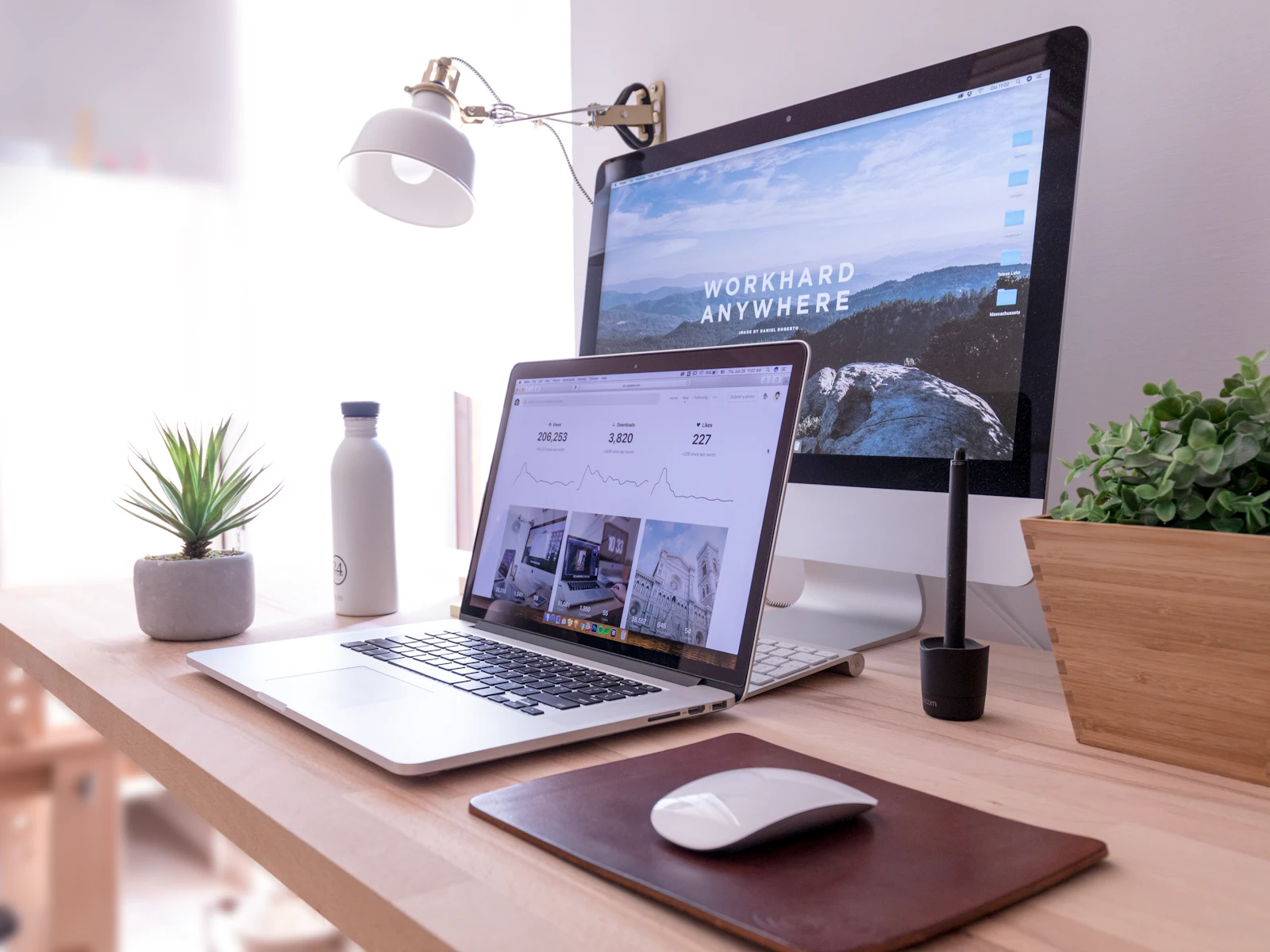 Laptop and desktop monitor on a designer's desk