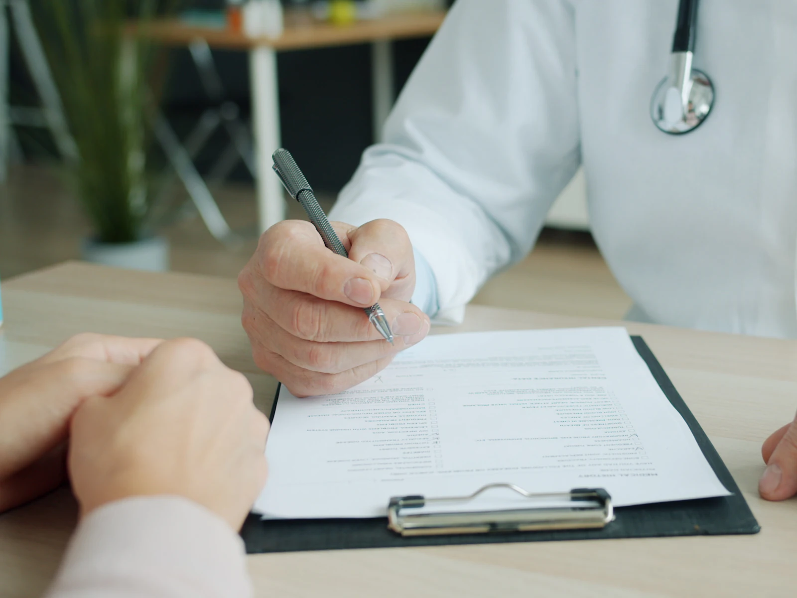 Doctor writing on a patient's chart